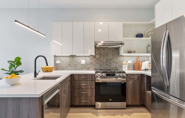 a kitchen with white cabinets and stainless steel appliances