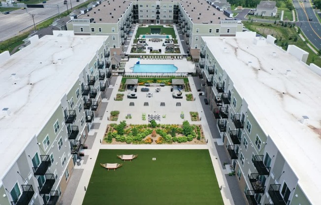 A large apartment complex with a pool and green spaces.