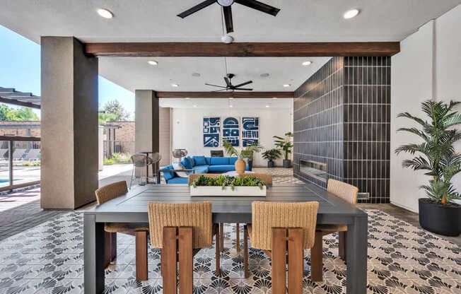 A dining room with a table and chairs.