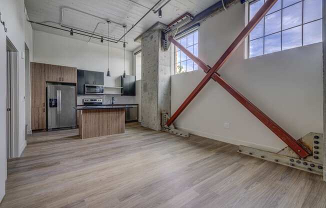 an open kitchen and living room with a large red x on the wall