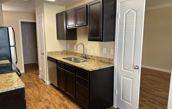 B4 | Galley Style kitchen | Granite Countertops | Wood style flooring