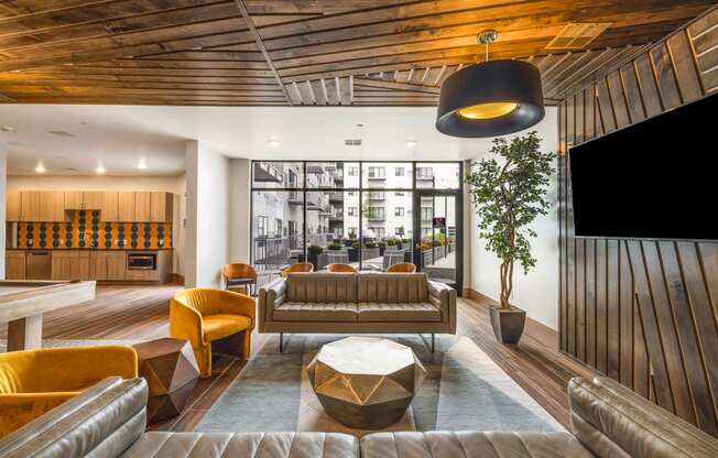 a lounge area with couches and chairs and a television