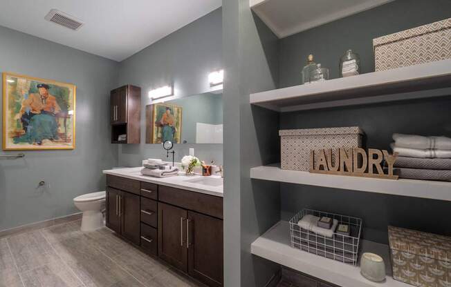 A modern bathroom with dual sinks, quartz countertops, and contemporary cabinetry.