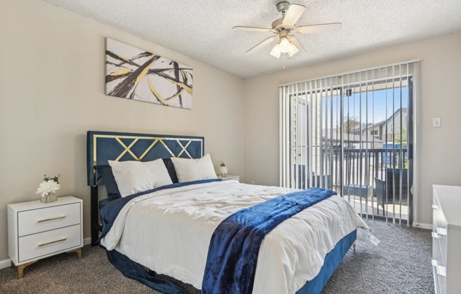 a bedroom with a bed and a ceiling fan