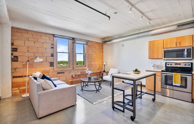 a living room with a couch and a kitchen with a table