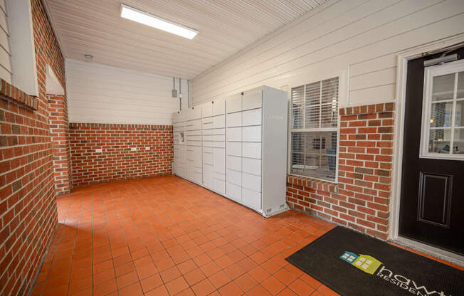 a storage room with a brick wall and a door