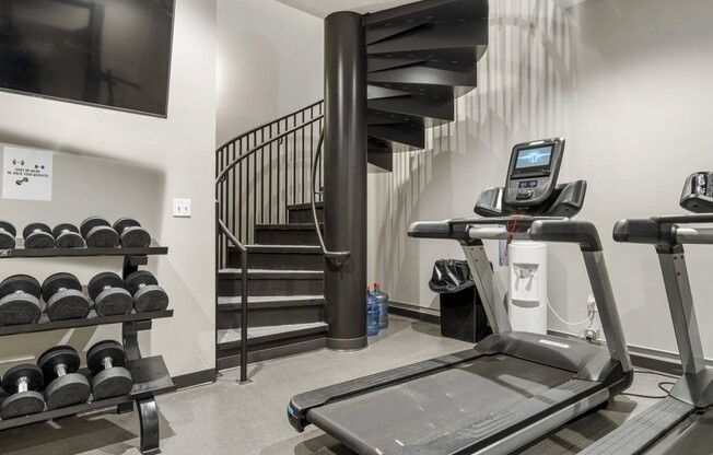 Elevate your fitness routine at Flats on Archer with our modern gym, featuring state-of-the-art equipment and a sleek design. Whether you're lifting weights or hitting the treadmill, this space supports your wellness journey. Schedule a tour today!