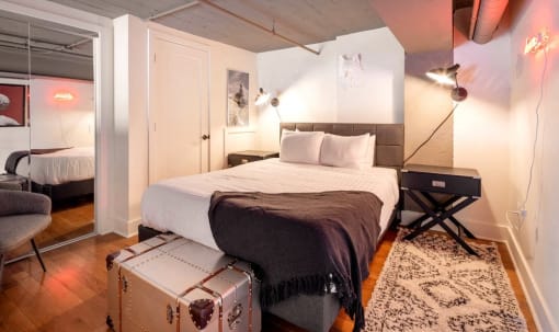 a bedroom with a bed and a suitcase