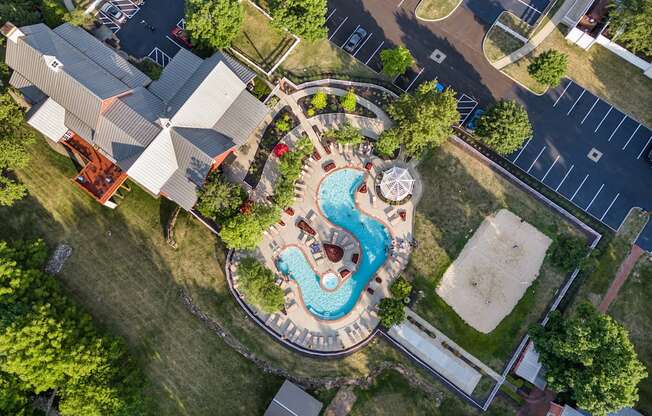 an overhead view of a swimming pool in a backyard with a house and a neighborhood at The Charleston, Columbus