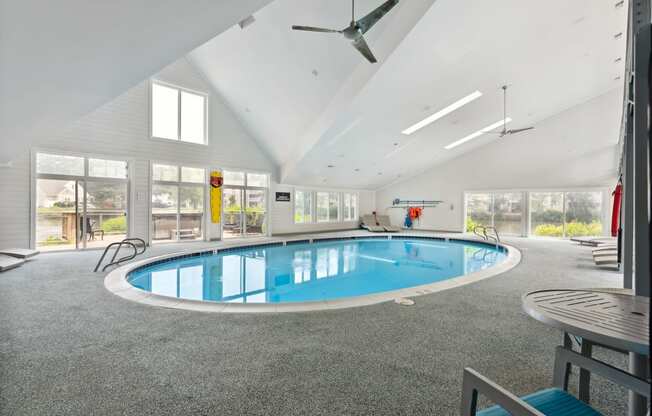 a large indoor swimming pool with a ceiling fan at Linkhorn Bay Apartments, Virginia Beach, Virginia