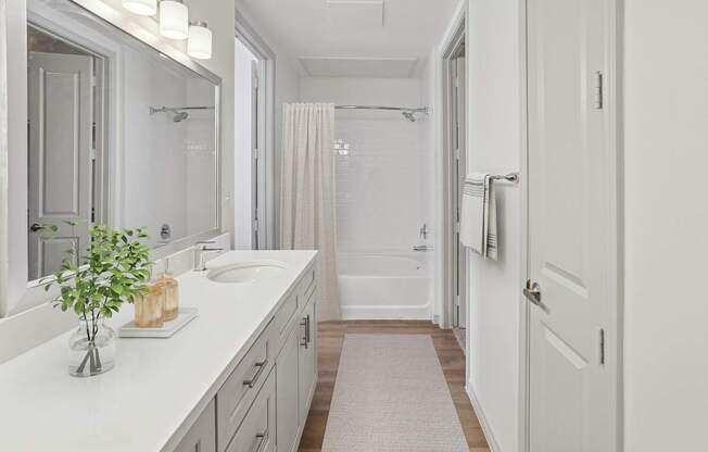 A bathroom with a white sink and a white tub.
