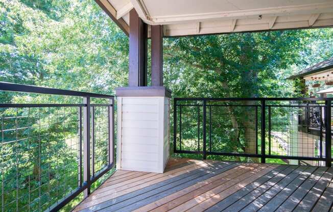 a balcony with a view of trees and a deck