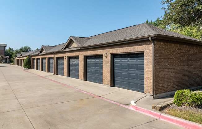 a row of garage doors on a brick building