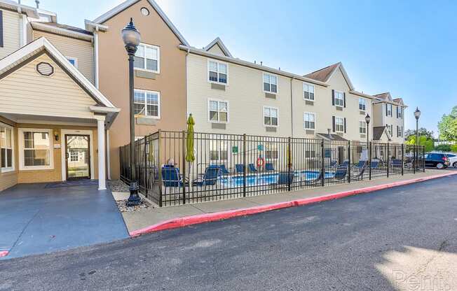 A sunny day at a residential building with a playground in front.