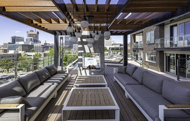 A wooden deck with a couch and a table.
