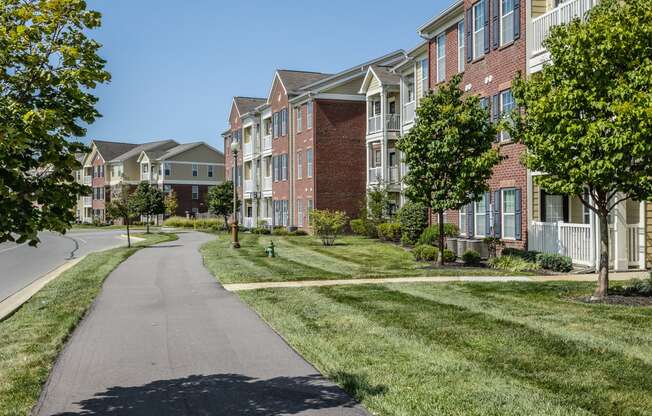 a sidewalk in front of a row of houses