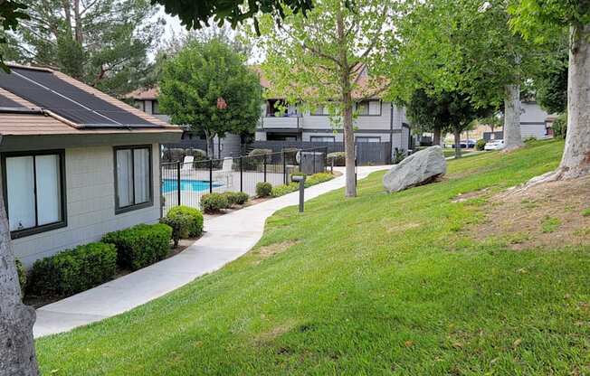 Grassy walkway around office and pool area at Dove Ridge Apartments.