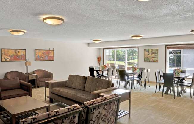 A living room with a couch, chairs, and a coffee table.