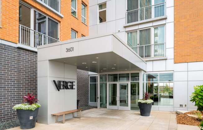 the front entrance of a building with the verge building name on it