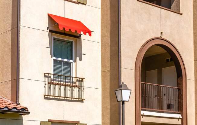 a building with an awning and a street light in front of it