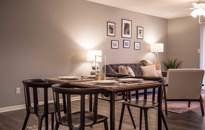 a dining room with a table and chairs and a couch