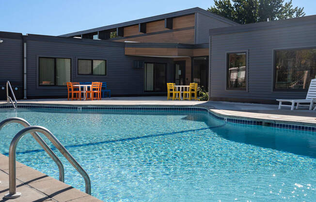 a swimming pool with a house in the background