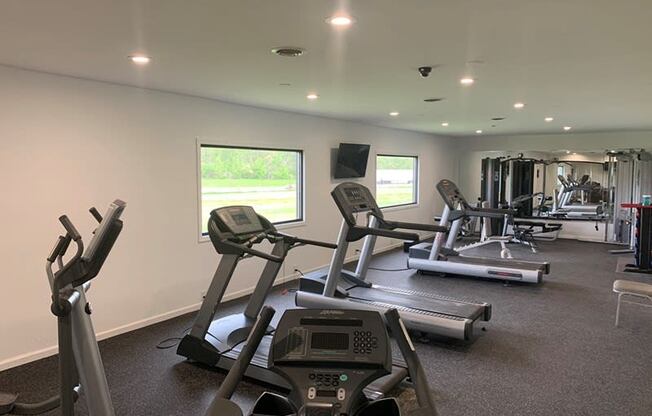 a gym with treadmills and other exercise equipment