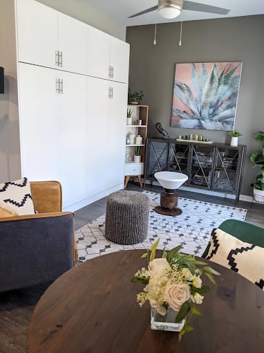 a living room with a table with flowers on it at GrandView Flats and Townhomes, Granger, Indiana, 46530