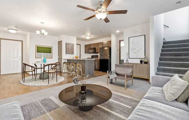 A modern living room with a grey sofa and a glass coffee table.