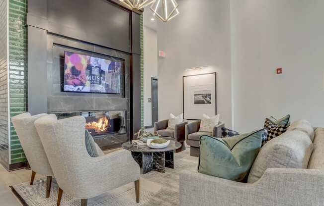 a living room with couches and chairs and a fireplace