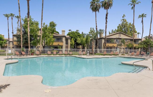 a group of palm trees next to a swimming pool