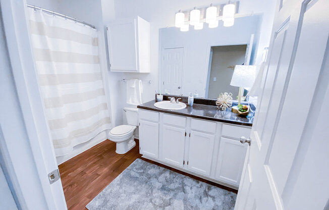 Mirrored Vanity with bathroom storage at The Villas at Katy Trail in Uptown Dallas, TX, For Rent. Now leasing Studio, 1, 2 and 3 bedroom apartments.