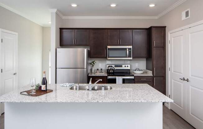 A kitchen with a white counter top and brown cabinets.