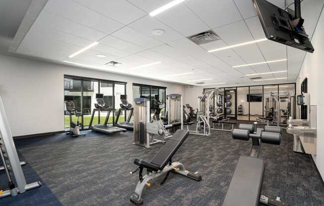 Fitness center with a variety of equipment and large windows