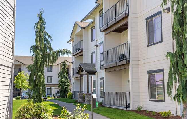 A sunny day at a residential apartment complex with a clear blue sky at Riverplace Apartment Homes, Independence, 97351