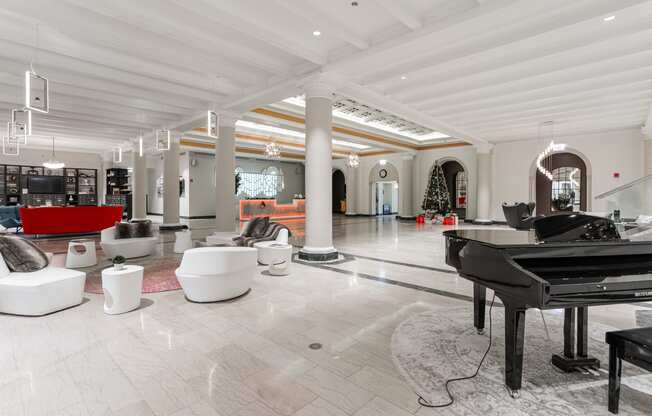 a grand piano sits in the middle of a large room with furniture and a piano