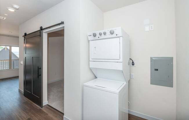 a white washer and dryer in a room with a door to a closet at The Crossings at Windsong, Arizona