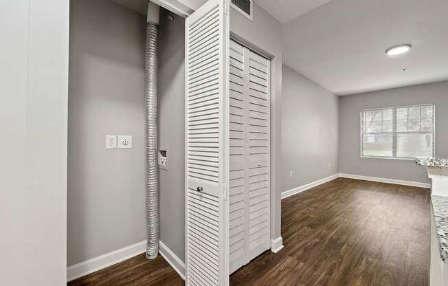 A room with a white door and a window.