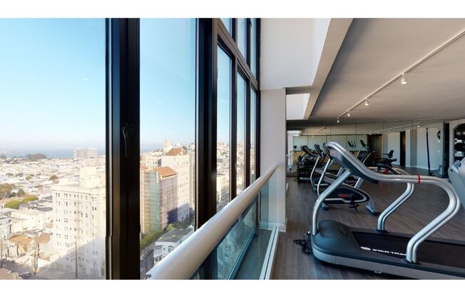 an image of a gym with a view of the city
