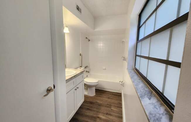 an empty bathroom with a toilet and a sink