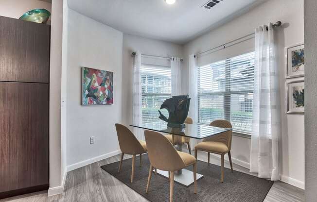 a dining room with a glass table and chairs at Legacy Flats, Texas