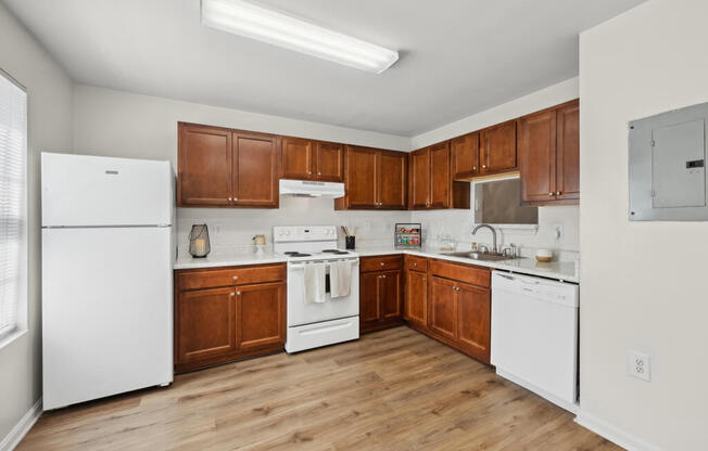 a kitchen with white appliances and wooden cabinets