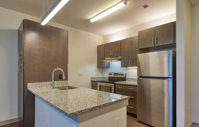a kitchen with granite counter tops and stainless steel appliances