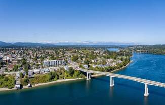 a bridge over a body of water with a city in the background and a river at Spyglass Hill Apartments, Washington