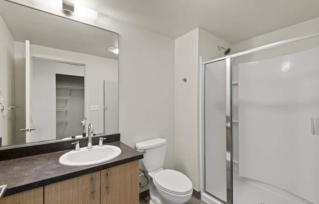 a bathroom with a toilet sink and shower