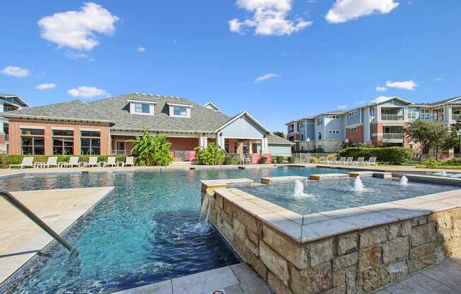 A pool with a waterfall and a sign that says "Swimming".