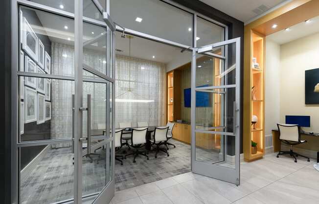 a conference room with glass doors and a table and chairs