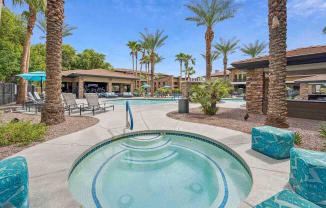 A pool surrounded by palm trees and lounge chairs. at The Laurel Apartments, Arizona, 85286