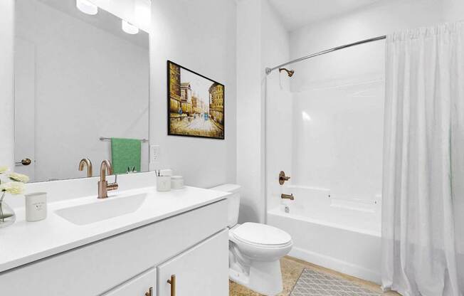 A white bathroom with a toilet, sink, and shower.