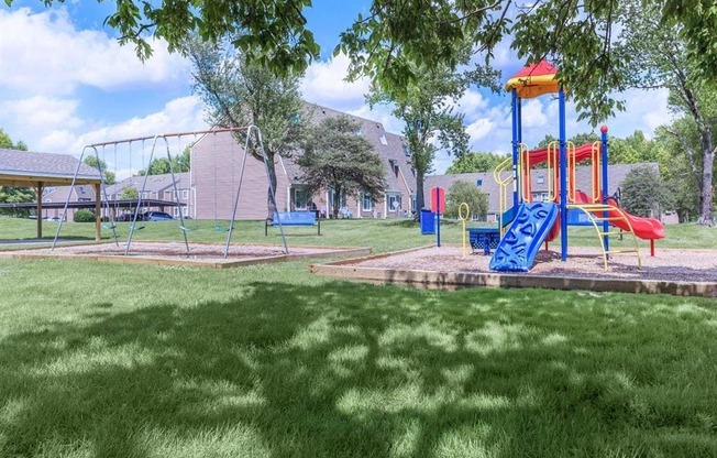 a childrens park with a playground and a swing set